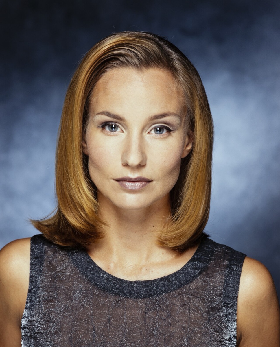 Studio portrait of a woman facing the camera straight on with her head level, both eyes fully visible